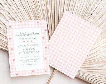 May include: Pink and white gingham birthday invitation with heart accents. The invitation reads "our little sweetheart is turning one" and includes event details. A matching flag is also visible.