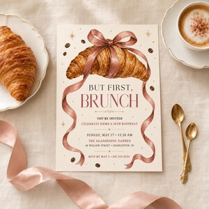 May include: A rectangular invitation card featuring a watercolour illustration of a golden-brown croissant tied with a dusty pink ribbon. The text reads: BUT FIRST, BRUNCH. YOU'RE INVITED. CELEBRATE EMMA'S 30TH BIRTHDAY. SUNDAY, MAY 17. 11:30 AM. THE GLASSHOUSE GARDEN. 48 WILLOW STREET. CHARLESTON, SC. RSVP BY MAY 5. 843 555 0192.
