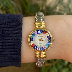 May include: A set of three ceramic mugs with a speckled, matte finish in cream, light grey, and dark grey. Each mug has a simple, minimalist design, ideal for coffee or tea.