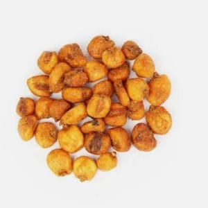 May include: A pile of roasted corn kernels, golden brown in color, with a slightly textured surface. The kernels are arranged in a loose cluster against a white background, showcasing their individual shapes and textures.