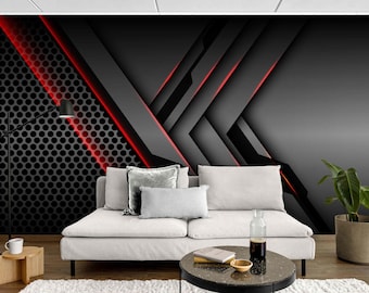 May include: Abstract geometric wall mural in shades of grey and black with red accent lines. The design features layered shapes and a perforated metal panel. A white sofa with cushions and a coffee table are in front of the mural.