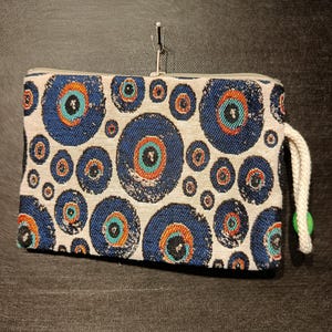 Bolso de mano con diseño de ojo malvado: bolsa con cremallera de tapiz de gobelino turco, pulsera Nazar para protección y estilo.
