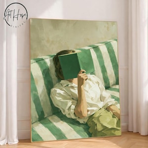 May include: A framed art print depicts a person reclining on a green and white striped sofa, holding a green book in front of their face. The person is wearing a white shirt and green pants. The artwork has a soft, painterly style.