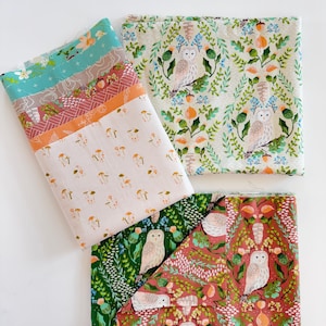May include: Several folded fabric pieces with various patterns are displayed. One features mushrooms, another has owls and foliage, and others have floral and geometric designs. The color palette includes teal, orange, pink, and green.
