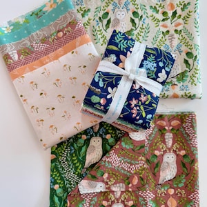 May include: A collection of fabric bundles with various floral and woodland patterns. The fabrics feature designs with mushrooms, owls, and botanical elements in shades of teal, pink, and navy, tied with a white ribbon.