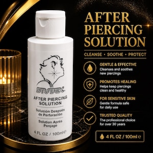 May include: White bottle of Studex After Piercing Solution. The bottle has a white cap and a black and white graphic of a profile with a star. The bottle contains 4 fl oz / 100ml of solution. The text on the bottle says "CLEANSE • SOOTHE • PROTECT".