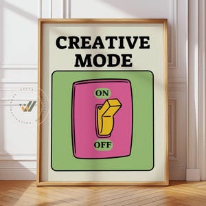Può includere: Stampa incorniciata con la scritta "CREATIVE MODE" sopra un interruttore rosa e giallo, impostato su "ON" all'interno di un quadrato verde. La stampa è in una cornice di legno, ideale per un ufficio.