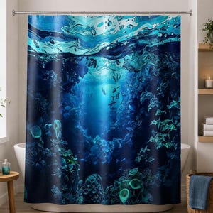 May include: A blue shower curtain featuring an underwater scene. The design depicts a vibrant coral reef with various marine life, including fish and coral formations. The curtain has a dark blue background with lighter blue and turquoise accents.