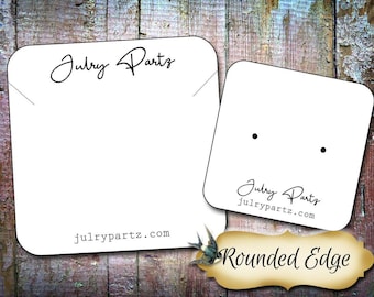 May include: Two white square jewelry display cards with rounded corners. The larger card features the text Julry Partz and julrypartz.com. The smaller card has two holes for earrings, the text Julry Partz, and julrypartz.com. A gold label reads Rounded Edge.