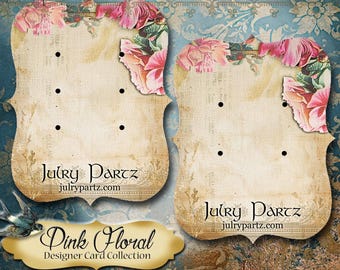 Peut inclure: Deux présentoirs à boucles d'oreilles avec un motif floral vintage. Les cartes sont beiges avec des accents floraux roses et le texte "Julry Partz" et "Pink Floral Designer Card Collection".