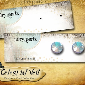 May include: A pair of iridescent blue earrings with a celestial veil design. The earrings are displayed on a white card with the text "julrypartz.com" and "Celestial Veil Designer Card Collection".