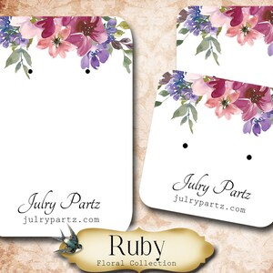 May include: Two blank earring display cards with a watercolor floral design in shades of pink, purple, and green. The cards have the text "Julry Partz" and "julrypartz.com" printed on them. The text "Ruby Floral Collection" is printed below the cards.