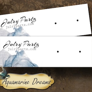 May include: Two white cards with black dots for earring display. The cards have the text "Julry Partz julrypartz.com" and "Aquamarine Dreams" printed on them.