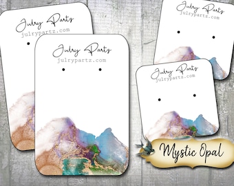 Puede incluir: Cuatro tarjetas de exhibición de aretes con un fondo de acuarela con un diseño azul, morado y dorado. Las tarjetas tienen el texto "Julry Parts" y "julrypartz.com" impreso en ellas. Una tarjeta también tiene el texto "Mystic Opal" impreso en ella.