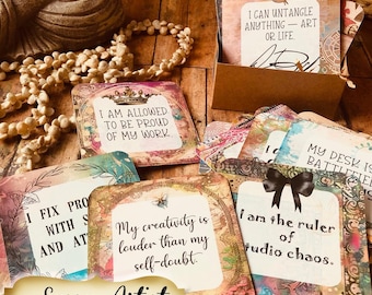 May include: A set of square affirmation cards with rounded corners, featuring colorful artistic backgrounds and black text. Phrases include I am allowed to be proud of my work, My creativity is louder than my self-doubt, and I am the ruler of studio chaos.