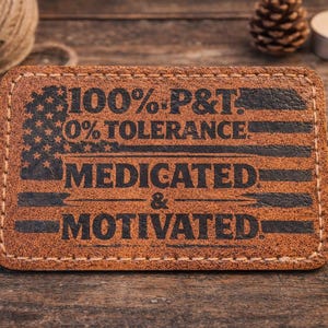 May include: A white ceramic mug with a black handle and the text "But First, Coffee" in a bold, black font. The mug is set against a blurred background, suggesting a cozy setting.