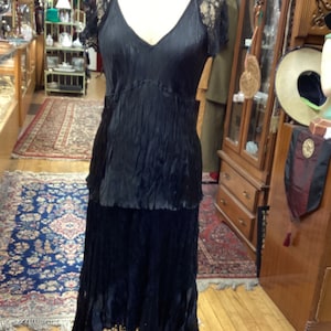 Layers and panels of crinkled satin and lace is form fitting and flattering