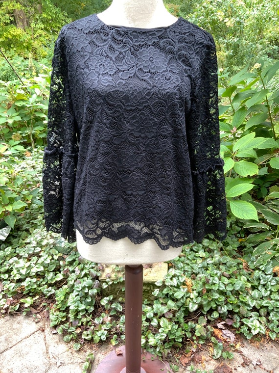 Black lace blouse with gorgeous sleeves is a size 