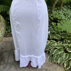 Floral lace adorns this fine cotton Victorian petticoat