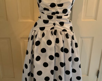 POW! You won't be missed in this oh-so-1980s boldly polka-dotted dress