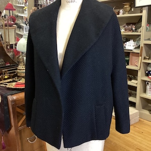 Basket-weave black wool coat styled by Frank Gallant for Marshall Fields in the 1960s
