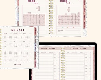 May include: A collection of open planners and a tablet, featuring pages for travel, mood tracking, and savings. The planners have a marble-like design with pink accents and gold spiral binding. The tablet displays a page with coconuts in water.