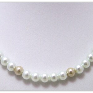 May include: A white pearl necklace with gold beads. The necklace is made of small, round pearls and gold beads.