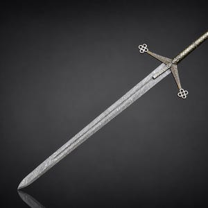 May include: A double-edged sword featuring a patterned Damascus steel blade with a visible wavy grain. The hilt includes a crossguard with four-lobed quatrefoil terminals and a textured metallic grip ending in a circular pommel.