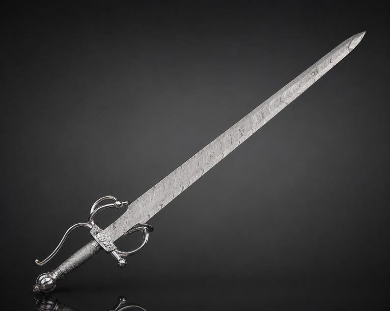 May include: A rapier with a long, pointed blade featuring a distinct wavy Damascus steel pattern. The hilt is constructed from polished silver-toned metal, showcasing a complex swept-hilt guard, a textured cylindrical grip, and a rounded pommel.