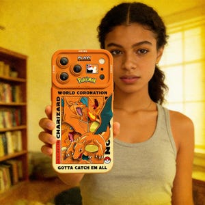 May include: Orange phone case with a Charizard design from Pokémon. The case includes the text "WORLD CORONATION" and "GOTTA CATCH EM ALL". The Pokémon logo and the text "PLAVI" are also visible.