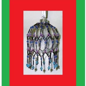 May include: A clear glass Christmas ornament with a beaded cage and blue and purple accents. The ornament has a beaded fringe hanging from the bottom.
