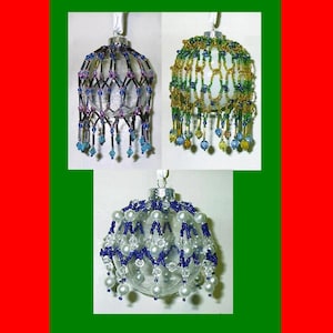 May include: Three clear glass Christmas ornaments with beaded embellishments. One has blue and purple beads, another has green and gold beads, and the third has blue and white beads. Each ornament has a silver cap and a white ribbon for hanging.