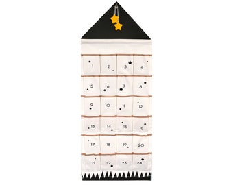 May include: A white fabric advent calendar with 24 numbered pockets, a black triangular roof with two yellow stars, and a black and white zig-zag border at the bottom.