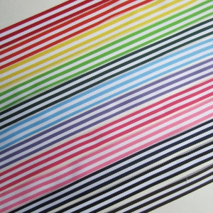 May include: A set of striped ribbon in various colors, including red, yellow, green, blue, purple, pink, and black. The ribbon is arranged in a diagonal pattern, with the stripes running parallel to each other.