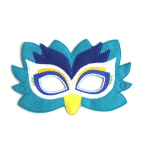 May include: A blue, yellow, and white felt bird mask with a beak and eye holes.