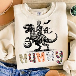 Funny Halloween Mummy T-Rex Skeleton Shirt, Cute Spooky Dino Graphic Tee, Trick or Treat Costume T-Shirt, Pink Oversized Halloween Top