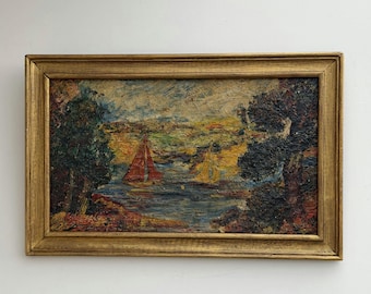 May include: An oil painting in a gold-toned wooden frame depicting a landscape with a body of water, two sailboats with red and yellow sails, and dark trees on the sides. The textured brushstrokes feature a palette of blue, green, and yellow.