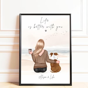 May include: Framed art print featuring a woman and a dog on a beach. The woman, with blonde hair, holds a coffee cup. The text reads "Life is better with you" above the names "Alison & Lola". The dog is brown and white.