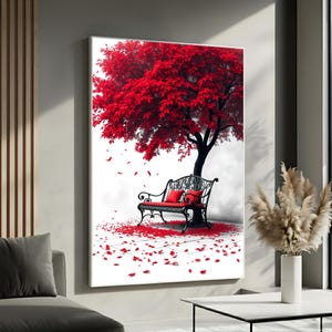 May include: A framed art print depicts a park scene with a black wrought iron bench under a vibrant red tree. Red leaves and petals are scattered on the ground. Two red pillows rest on the bench, enhancing the romantic ambiance.