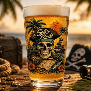 May include: A clear glass filled with golden beer featuring a colorful graphic of a skull wearing a pirate hat, palm trees, a treasure chest, a map, and a ship. The text Salty Roads is printed in a stylized font above the skull illustration.