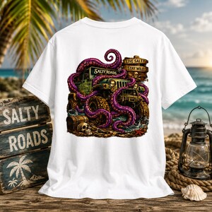 May include: A white t-shirt featuring a graphic print of a green off-road vehicle wrapped in purple octopus tentacles. The design includes a wooden sign with the text "LIVE SALTY STAY WILD" and "SALTY ROADS," a skull, and a treasure chest.