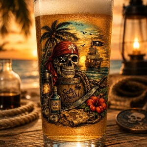 May include: A clear glass filled with golden beer featuring a printed graphic of a skull wearing a red bandana and eye patch, a wooden barrel labeled Salty Roads, a bottle of rum, a sword, a compass, coins, and a ship on the ocean at sunset.