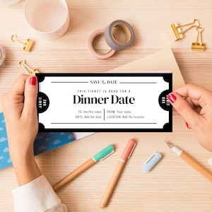 May include: A black and white "Dinner Date" ticket with the text "Save the Date." The ticket includes fields for the recipient's name, date, and location. The image also shows pens, tape, and paper clips.