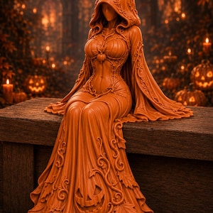 May include: An orange monochromatic figurine of a hooded figure wearing a gown adorned with vine and leaf patterns. The figure features a pumpkin-shaped bodice and a skirt with a carved jack-o'-lantern face at the hem, all in a smooth finish.