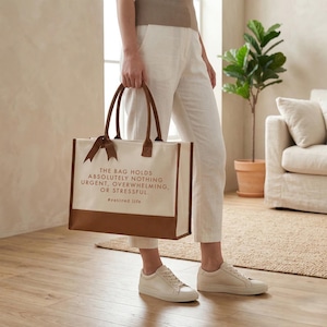 Tote bag design featuring a humorous quote reading the bag holds absolutely nothing urgent overwhelming or stressful displayed in bold uppercase lettering with a clean and centered layout; includes a small retired life phrase underneath for added personality; designed with a minimal modern style that highlights the text clearly; ideal for retirement gifts, everyday use, or carrying essentials with a lighthearted and relaxed vibe