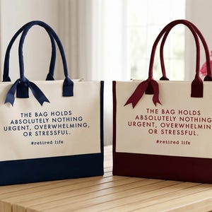 Tote bag design featuring a humorous quote reading the bag holds absolutely nothing urgent overwhelming or stressful displayed in bold uppercase lettering with a clean and centered layout; includes a small retired life phrase underneath for added personality; designed with a minimal modern style that highlights the text clearly; ideal for retirement gifts, everyday use, or carrying essentials with a lighthearted and relaxed vibe