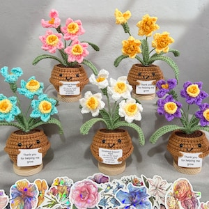 May include: A collection of handmade crochet flower arrangements in small brown pots with smiling faces. The flowers are in various colors, including pink, yellow, blue, white, and purple. The image also includes a set of flower stickers.