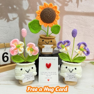 May include: Handmade crochet flower arrangements in white pots with smiling faces. The flowers include a sunflower, pink and white flowers, and purple and white flowers. Each pot has a small sign that says "Thank you for helping me grow."