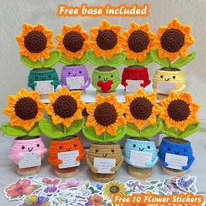 May include: A collection of handmade crochet sunflowers in colorful pots. Each sunflower has a brown center and orange petals. The pots are various colors, some holding small cards with text. The image includes the text "Free base included" and "Free 10 Flower Stickers".