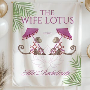 May include: A white banner with the text "THE WIFE LOTUS" and "Allie's Bachelorette" in purple. It features two monkeys under pink umbrellas, palm leaves, and a lotus flower design. Gold and white balloons are on the sides.